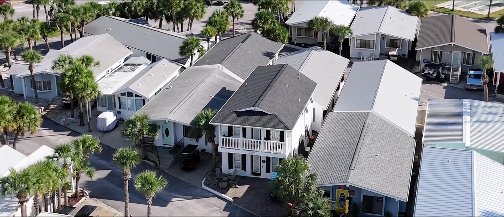 Facebook aerial of white-painted 25 Gulf cottage with patio seating