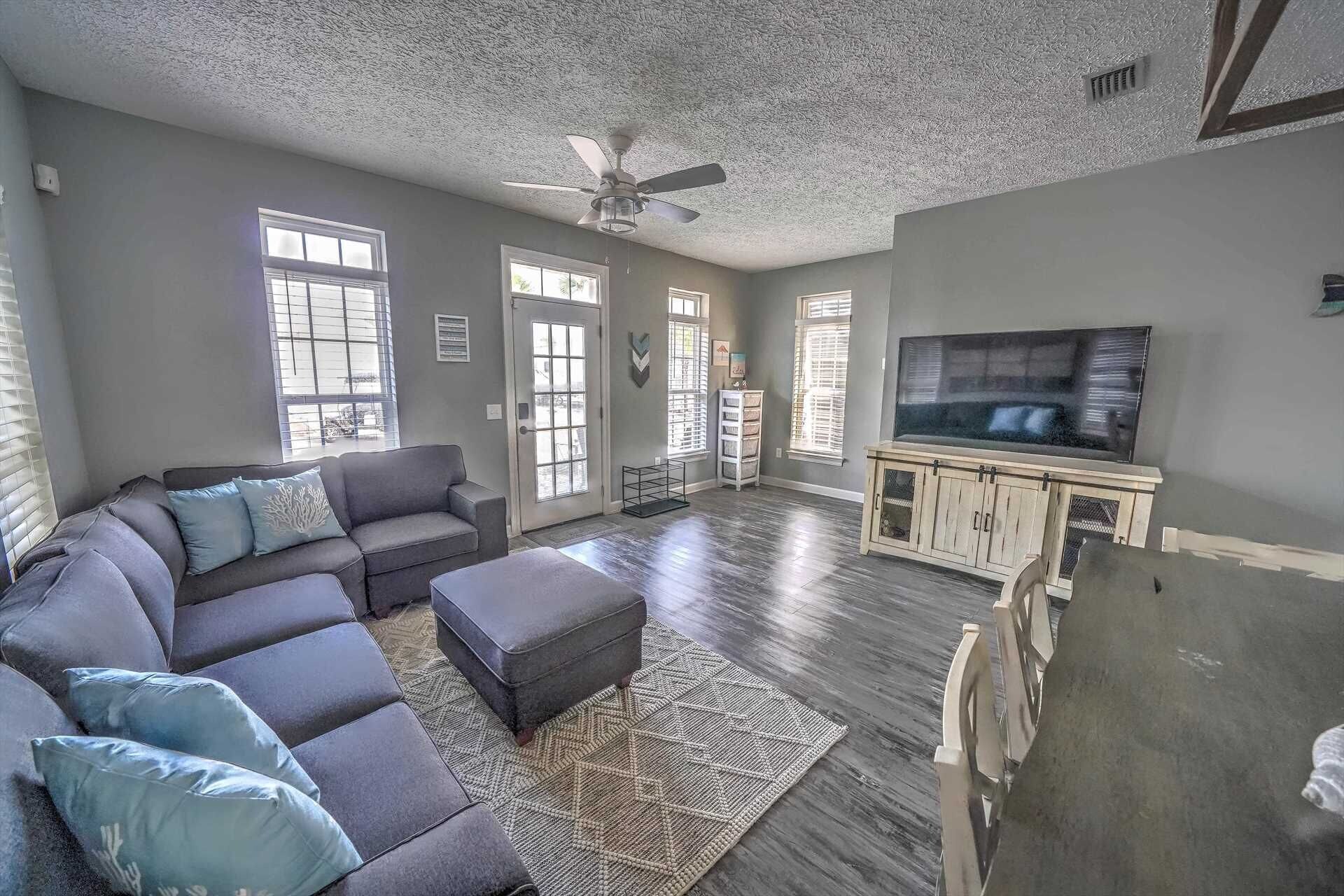 Living room facing the TV and kitchen beyond